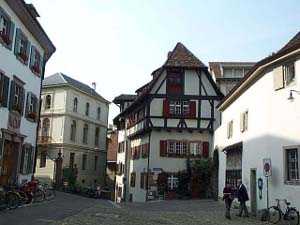 The buildings are three or four stories, painted white, brown timbered with steep roofs, and set at odd angles, testifying to their antiquity