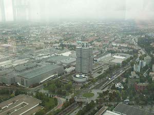 A tall modern building in four adjoining circular towers, with the lower circular museum to one side
