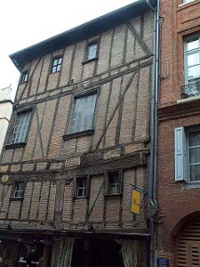 There is a great deal of noticeable sag near the center of this building, with the dark wood timbers not at all true but still framing and supporting the whole