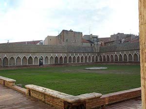 Looking somewhat like a cloister, this square green ground has a columned gallery all around with tombs.