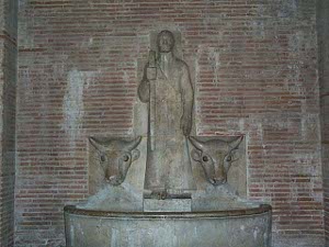 The statue shows a cowherd with the heads of two cows which are fountains