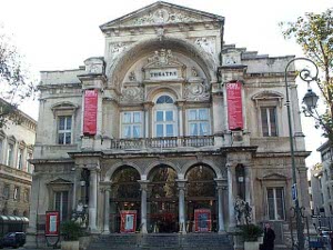 A very old building with two high stories, elaborate pillars, a balcony above, this theater dominates the neighborhood