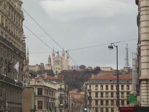 The basilica is in the distance, on a hill overlooking blocks of city buildings.  The towers are a distinctive beautiful architecture.