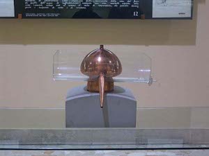 The still looks somewhat like a copper mushroom, with a long gentle conical spout descending from the cap to discharge the distillate