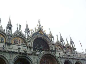 Statues adorn the niches and arches and towers abound on the roof of the Basilica of San Marcos