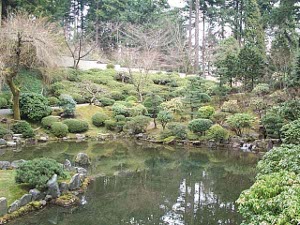 The pool occupies a basin shaped in the hillside, and surrounded by careful plantings