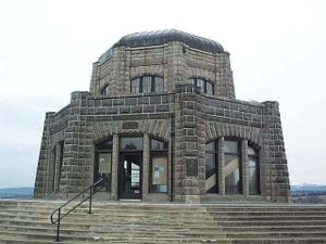 An octagonal dark stone folly built on top of a high protruding bank overlooking the Columbia River in both directions