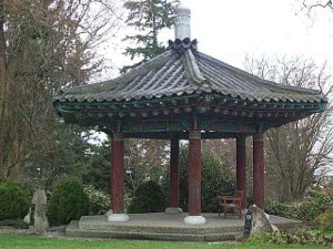 Resting on six massive redwood posts, the pavilion has a doubly tiled elaborate green roof with a white tower on top
