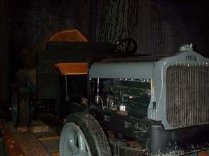 With a gray hood, the truck had no body; the driver sat on a plain wood bench and operated the vehicle, which had solid rubber tires
