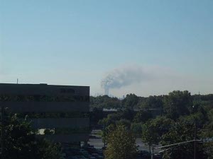 A thick plume of smoke fills the sky above the World Trade Center seen from New Jersey