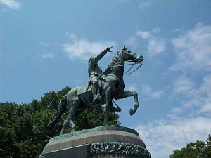 Colored green with age, the statue depicts General Putnam, astride his horse (left front foot up) and pointing ahead.