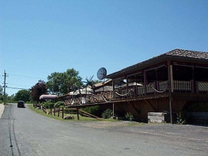 The restaurant looks like a beach house, with a large porch and a dish antenna