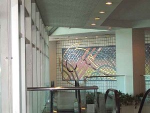 In the People Mover lobby, a bright red and blue and yellow geometric tile mural adds a splash of color