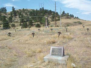 On a grassy hill the city fathers have erected wooden crosses over the graves whose markers have eroded away