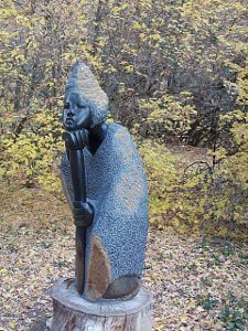 Head resting on hand, the figure of a thoughtful woman grabs the viewer's attention