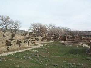 The large multi-roomed pueblo dwelling surrounds a circular stone construction.