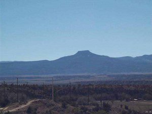 In the clear air, Pedernales is silhouetted against the blue sky, thirty-five miles away