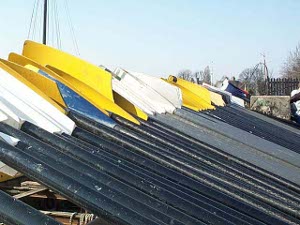 Black painted oars with yellow or white blades make a long line waiting for the race to start