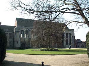 The Great Hall, about fifty feet tall at the peak, dominates the old part of the palace and reeks with history.  The long side is filled with tall, round-arched windows, letting in a lot of light.  A small circular tower hods a staircase to the balcony and loft.  In this view, the sandy drive surrounds a grassy lawn with one large central tree; behind this tree stands the Great Hall.