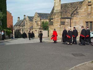 Clad in the formal black and red gowns of office, the Mayor and officers and councilman of Durham proceed to open the new civic year