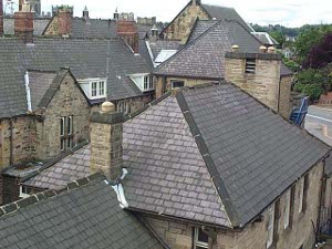The road passes high above the second-floor slate rooftops and brick chimneys of the stone Durham houses, making a lovely geometric pattern