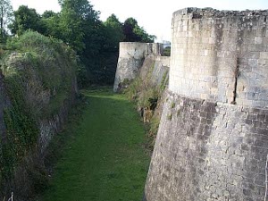 With stone walls about 12 feet high, this large moat, perhaps 15 feet wide, would be hard to cross