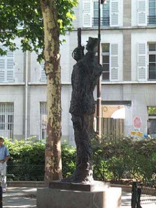 Capt Dreyfus is shown standing sharply erect, his back slightly arched backwards and his broken sword held stiffly at attention in front of his face