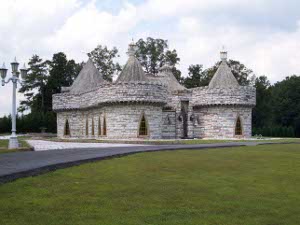 The Castle consists of four circular wings, each with a parapet topped with crenellations and a conical roof, surrounding a central area.  All construction is of a soft grey and beige stone, and the windows are fascinating - each shaped like a sharply triangular arch.