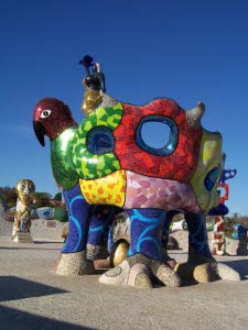 Looking a little like a children, this fifteen foot ceramic bird features a hole in its back and green, red, yellow, blue, lilac and other colors
