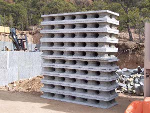 A pile of ten rastra forms, dach about two by eight feet, waiting to be built into walls of the new home.