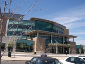 The modern Memphis library shows a curved front covered in green glass, with light tan concrete for contrast