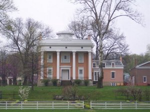 The stately red brick two-story Lanier Mansion in Madison, Indiana, with four tall white columns in front