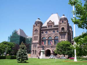 Red stone Romanesque architecture sets off the five-story building of the Ontario Provincial Legislature