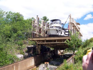 Two larger boats ride in tandem as the rail car rolls down the grade