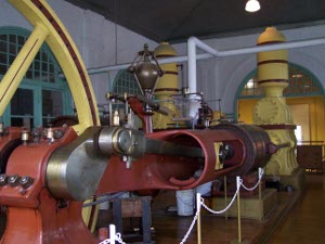 The enormous engine is painted red and yellow with stainless steel