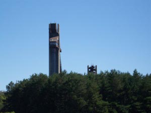 the back of the Olympic ski jump building, perhaps 100 feet high on top of a nearby hill