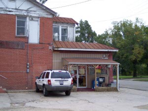 Nancy's Cafe looks most unprepossessing with a small red roof and a porch next to a small parking area.