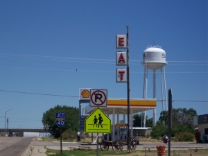 The restaurant sign, on a tall pole, says merely, 'Eat.'