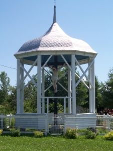 A covered shrine with a beautiful life-sized crucifix