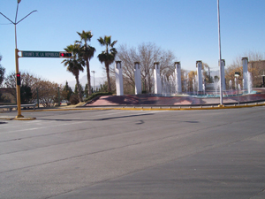 Seven white pillars with spurting water make a striking fountain