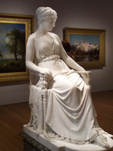 Sculpture of a seated woman in white marble in one of the galleries