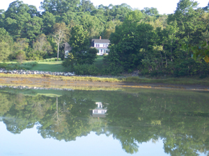 Clear waters reflect a house