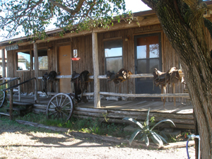 Saddles on the porch of a King Ranch building