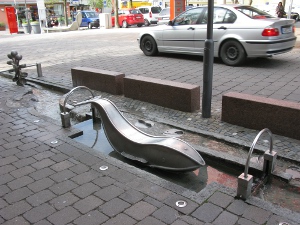 stainless steel sculptures adorn the four-brick wide fountain-fed waterway which flows for several blocks through the town