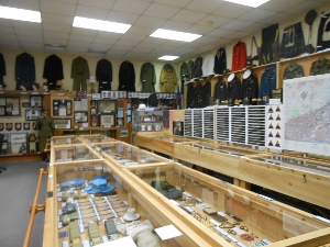 glass-topped wooden display cases reveal uniform items and military mementos