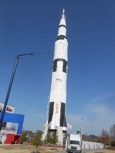 Towering hundreds of feet high, the Saturn V display is a model, but the real rocket is shown, its stages separated, inside the exhibit hall.