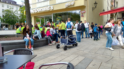 A large crowd of young people standing in front of McDonalds