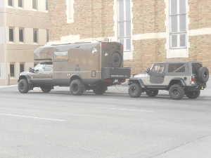 The Earth Roamer is a rugged and smooth pickup camper, and a jeep is in tow for off-road expeditions.