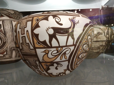 The design, in shades of tan against a white background, shows a deer and a bird