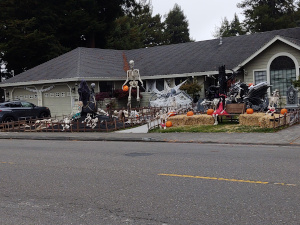 The yard of this California ranch house has a 15-foot skeleton holding a pumpkin, loads of pseudo-spider webs, dozens of gravestones, jack-o-lanterns and other related Halloween decorations.